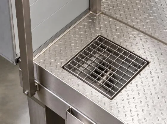 Square drain set into a checker-plate platform floor